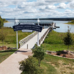 Carlton Landing Marina sign with dock and Lake Eufaula in background
